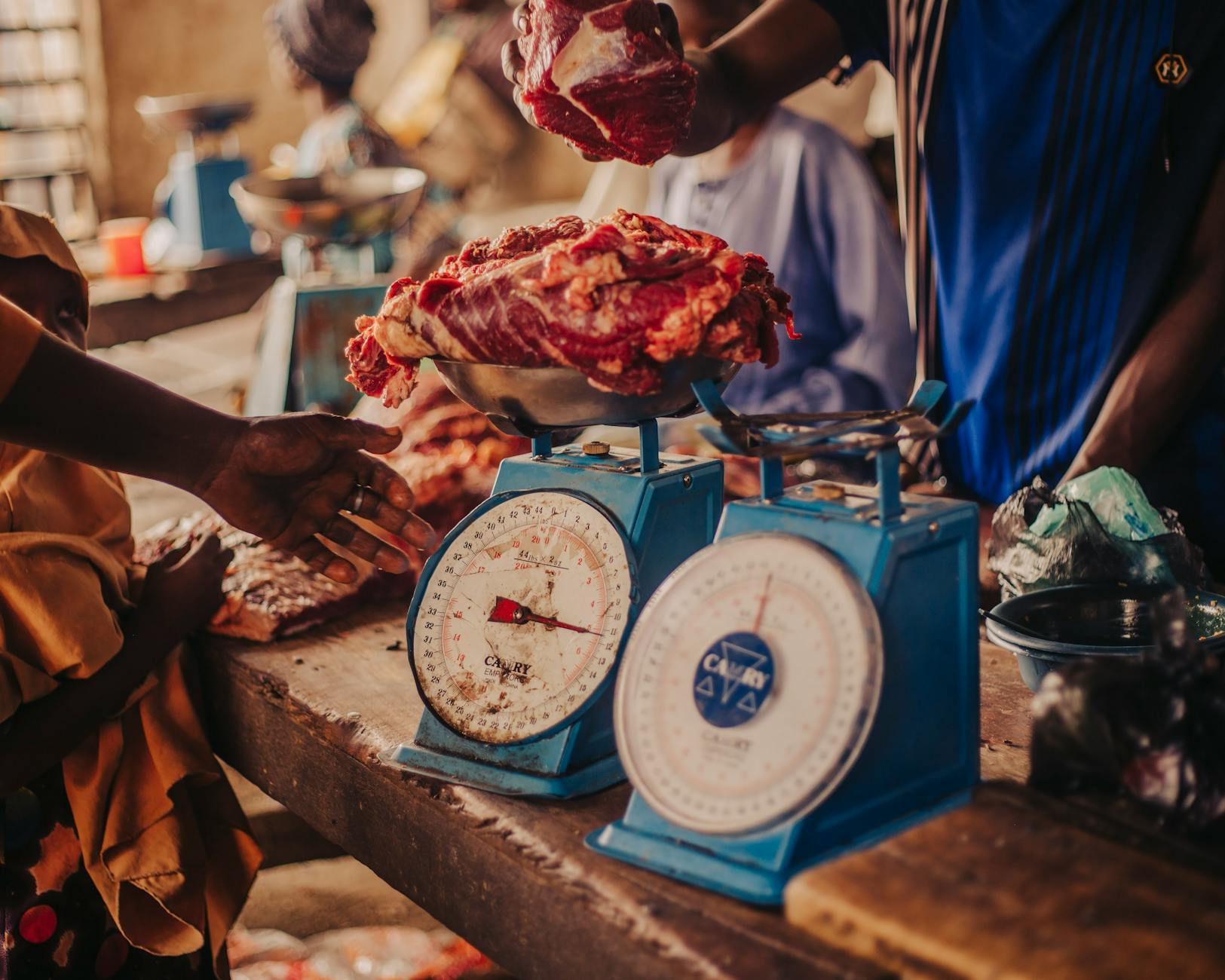 traditional market scene with meat on scales